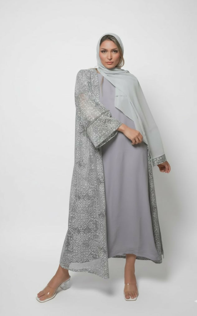 Modern women’s abaya consisting of three pieces decorated with lace with scarf