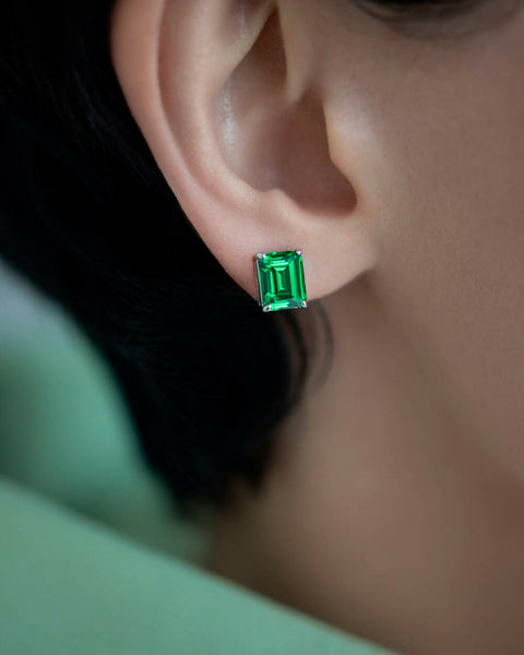 Green stud earrings in emerald cut