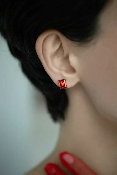 Red stud earrings in emerald cut