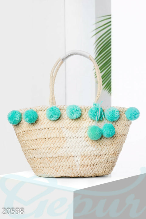 Straw bag with blue pompom