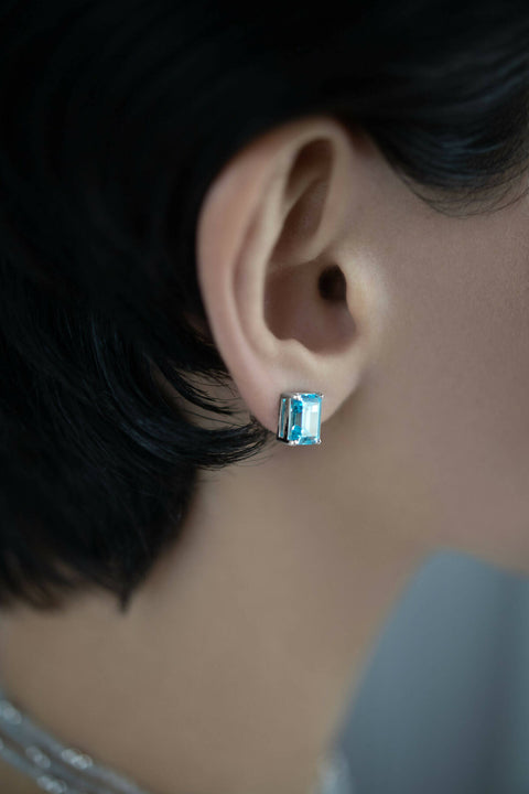 Light-blue stud earrings in emerald cut