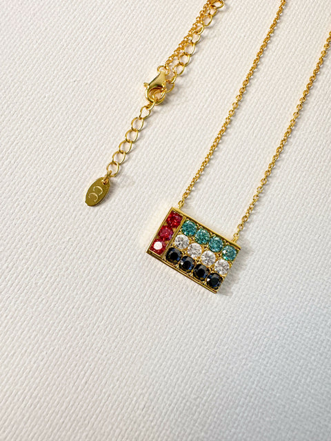 Necklace with colorful UAE Flag pendant on a white background