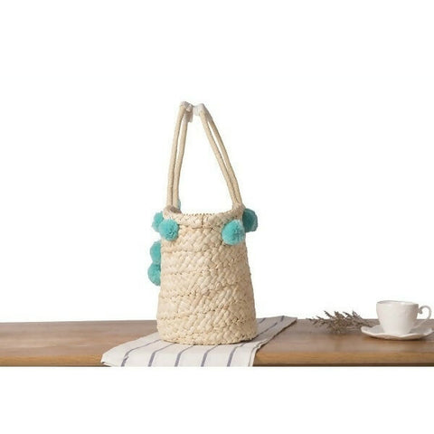 Straw bag with blue pompom