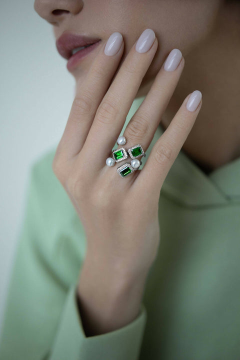 Ring with emerald-cut stone and a pearl