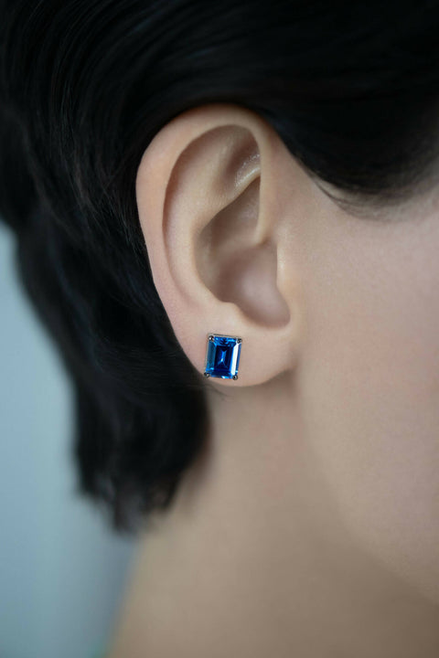 Dark-blue stud earrings in emerald cut