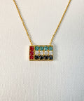 Necklace with colorful UAE Flag pendant on a white background