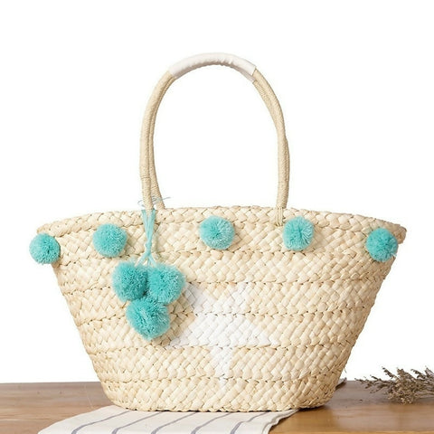 Straw bag with blue pompom